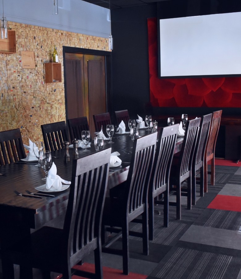 Lotus 20-22 people. Lotus is decorated with an entire wall of corks and copper accents throughout. This room is ideal for corporate meetings with a projector and large screen available for presentations.